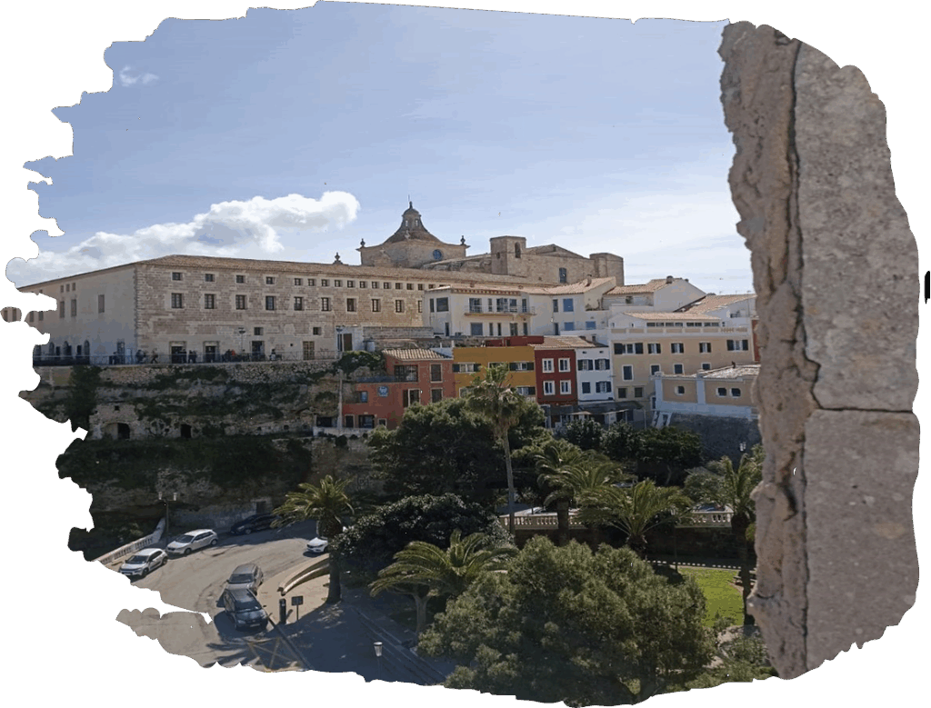 Historic European cityscape with colorful buildings and palm trees under a sunny sky.