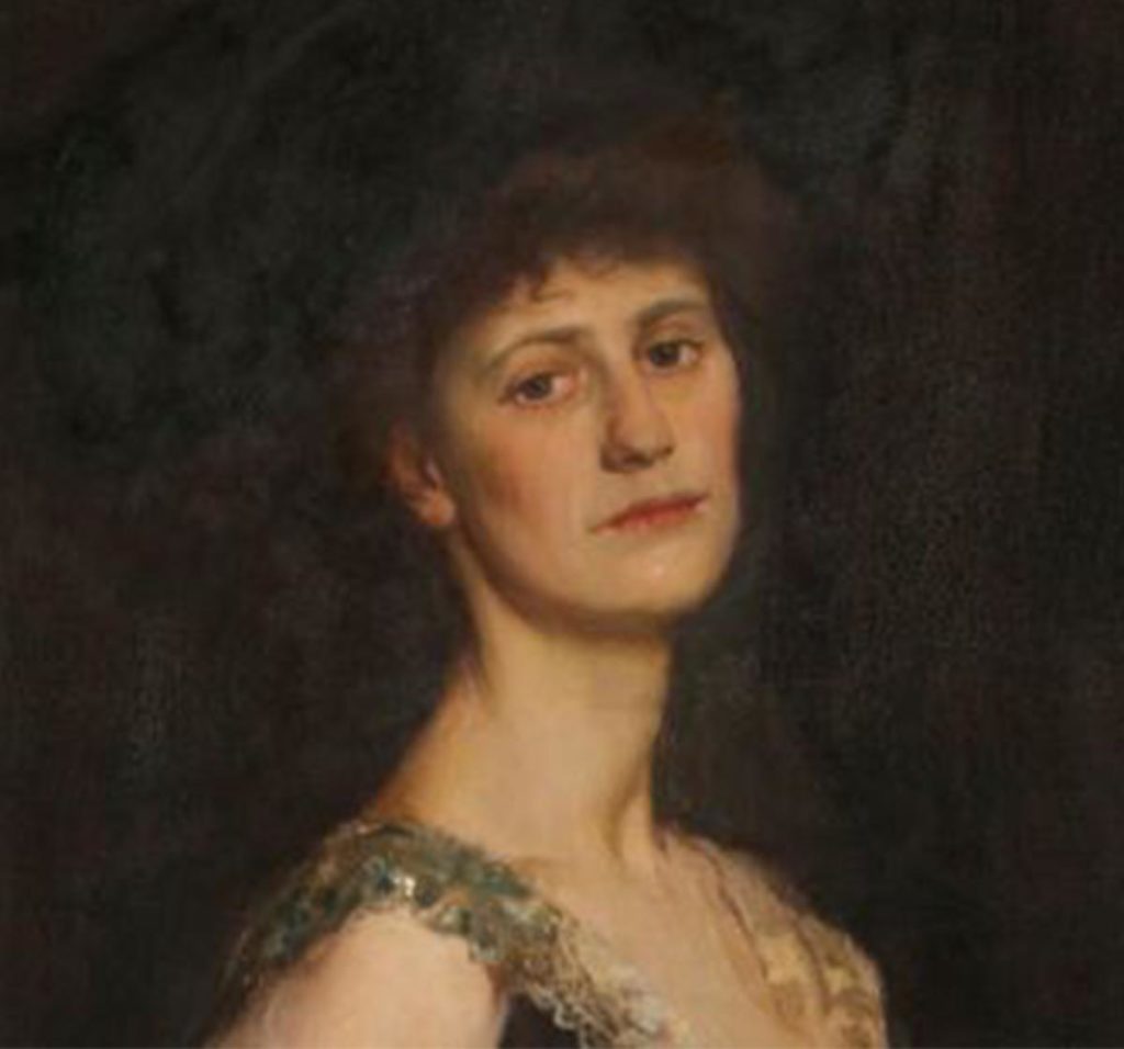 Portrait of a woman in an elegant dress against a dark background, exuding a serene and contemplative expression.