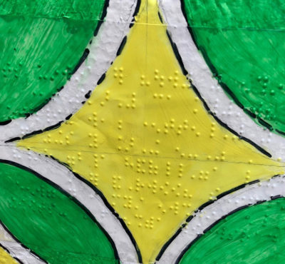 Textured yellow star-shaped pattern with green and white elements, resembling a tactile art piece.